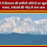 Beautiful view of the snow-capped Himalayan peaks in Mussoorie; traffic jams caused by crowds of tourists.