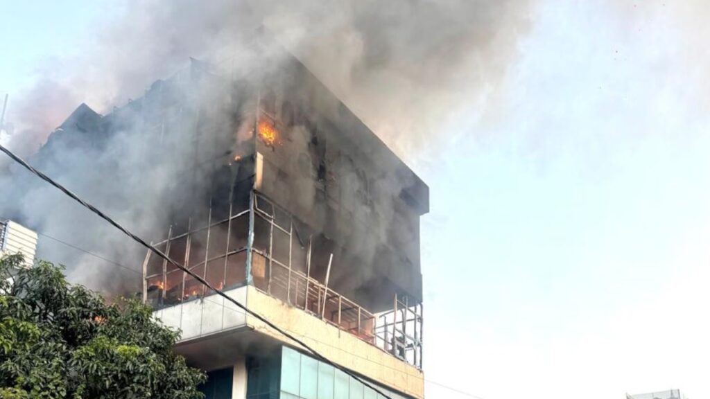 Massive fire breaks out at showroom and service center; plume of smoke visible from afar.